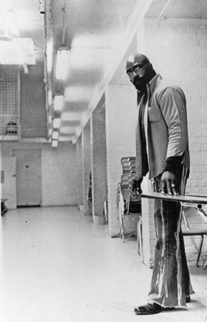 Former middleweight boxer Rubin “Hurricane” Carter stands near a desk at the old Death Row at Trenton State Prison in Trenton, N.J. Carter went through two trials and endured 19 years in prison before being cleared of a triple murder that happened in 1966.