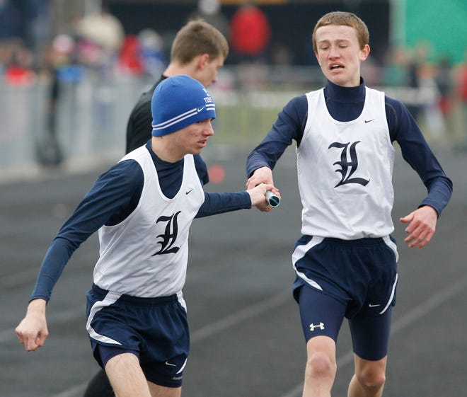 Nick Koczwara grabs the baton from Louisville teammate Stephen Stamp to complete a successful exchange in the 3,200 relay at Saturday’s Fairless Tri-County Invitational. The relay was a success for the Leopards, who won in a time of 8:48.92 on their way to capturing the team title.