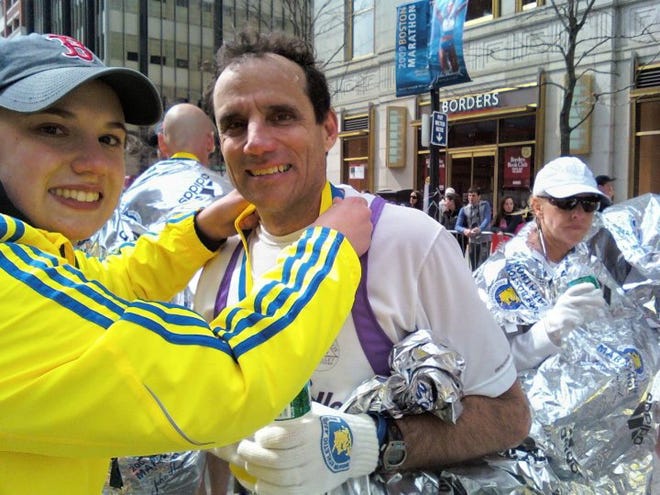 Don Palladini receives his medal for completing the Boston Marathon.