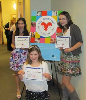 Medway students, from left, seventh-grader Riana Pozsgai, eighth-grader Margaret Mansfield and seventh-grader Juliana Darmofal, were among 100 middle-schoolers to be honored in Boston for their volunteer work.