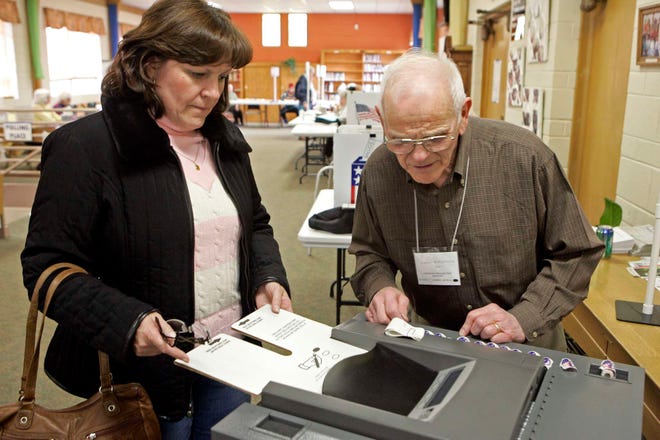 Mary Kay Spataro enters her ballot with the help of election judge Al Riportella on Tuesday, April 5, 2011, at Beth Eden United Methodist Church in Rockford.