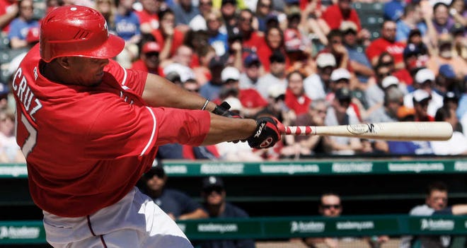 Texas Rangers' Nelson Cruz hits a two-run double during the eighth inning of a baseball game against the Seattle Mariners in Arlington, Texas, Wednesday, April 6, 2011. The Rangers won 7-3. (AP Photo/LM Otero)