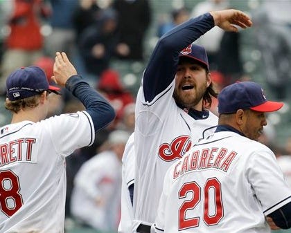 Cleveland Indians relief pitcher Chris Perez, center, celebrates with Adam Everett, left, and Orlando Cabrera after the Indians beat the Boston Red Sox 1-0.