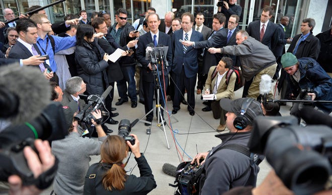 NFL attorney David Boies, center at microphone, addresses the media outside a federal courthouse after the NFL antitrust lockout hearing Wednesday. The Associated Press
