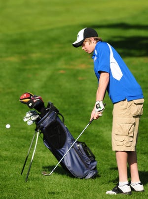 Dennis R.J. Geppert/The Holland Sentinel Saugatuck's Ben Shashaguay chips the ball onto the green during the SAC Boys Golf Jamboree Wednesday afternoon at Clearbrook Golf Course.