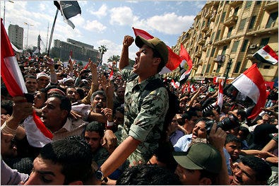 An army officer was carried on demonstrators' shoulders during a rally Friday in Tahrir Square in Cairo, but military leaders have been criticized of late.