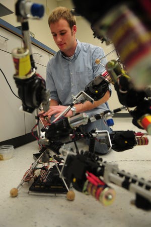 Jim Dratz works on a robot he helped build as part of an undergraduate project at Hope College.