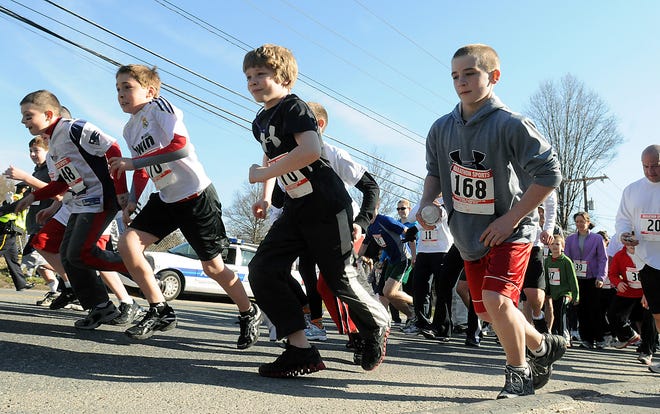 Participants jump from the starting line for the Brookside and Woodland Elementary Parent-Teacher Organization 5K race yesterday in Milford, which was part of Healthy Kids Week.