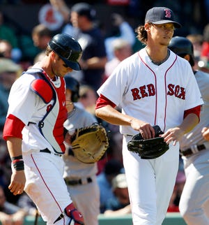 Boston Red Sox starting pitcher Clay Buchholz and catcher Jarrod Saltalamacchia react after giving up a three-run home run to New York Yankees' Russell Martin during the fourth inning of a baseball game at Fenway Park in Boston Saturday, April 9, 2011.
