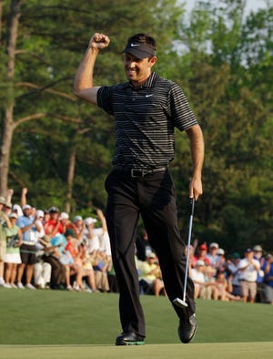 Charl Schwartzel celebrates after making the last of four straight birdies to end his final round at the Masters on Sunday. Schwartzel won by two shots over Adam Scott and Jason Day.