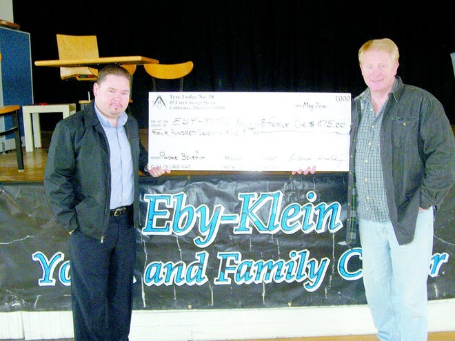 Presenting the check to Dave Anderson of Eby-Klein, is Jeff Richards, Worshipful Master of the Lodge.