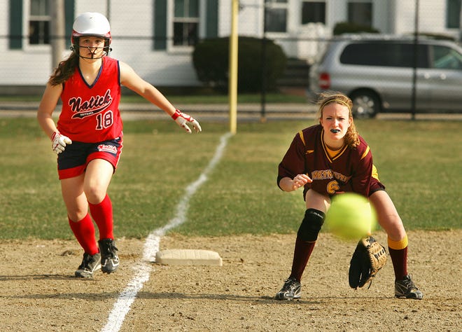Weymouth third baseman Samantha Milks waits to make a play the ball as Natick's Lexi Gifford looks towards the plate during a game Monday, April 11, 2011.