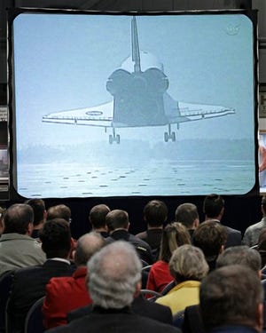 Members of the public view a broadcast from NASA at the National Museum of the U.S. Air Force in Dayton. NASA announced Tuesday that the museum would not be one of the sites to become home to one of the nation's four retiring space shuttles.