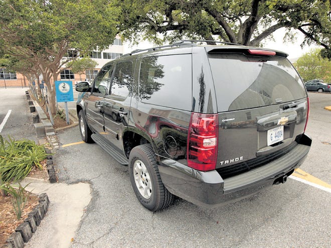A Chevrolet Tahoe with a Mississippi Government license plate sits in the parking spot of the Biloxi mayor outside City Hall in Biloxi, Miss., in March. Officials have gone on a spending spree with BP money, according to an Associated Press investigation.