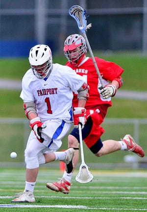Fairport's Jerry Warner (1) and Canandaigua's Mark Greer (14) during a game at Fairport on Tuesday 12, 2011.