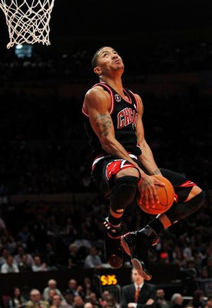 Chicago Bulls' Derrick Rose goes in for a dunk during the second half of the Bulls' NBA basketball game against the New York Knicks Tuesday, April 12, 2011, in New York. Rose scored 26 points as the Bulls won 103-90. (AP Photo/Frank Franklin II)