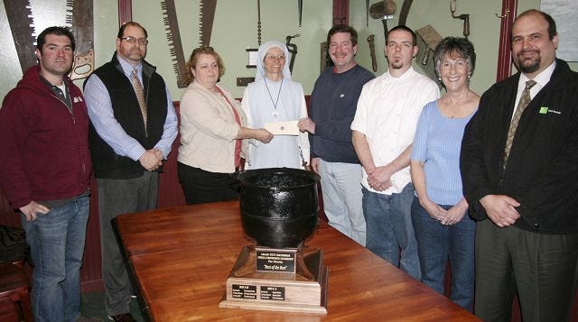 John Nolan/Times photo
Participants in the second annual Lilac City Eateries Chili-Chowder Cookoff gathered in The 306 Restaurant last week to present a check for over $1,100 to St. Charles Children's Home. From left are Joel Harris (Dos Amigos), Christopher Ragno, Susan Jackson-Rafter (Portable Pantry), Sister Mary Rose, Vince Crout-Hamel and Chef Aaron Varney of The 306 Restaurant, Marcia Johnson (Marcia's Takeout) and Paul Anatone.