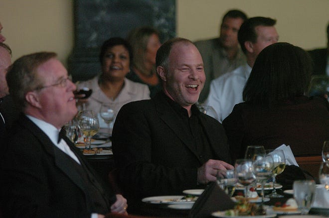 Author Jackson Katz jokes with people at his table during the Reach For The Stars event held at Mid Town Campus Wednesday night. Katz was the Keynote speaker at this years annual event.