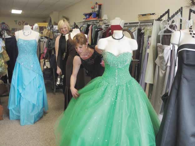 Freedom House Transitional Shelter Advocate Annette Williams, foreground, and Special Projects Manager Stephanie Cartwright check out the array of prom dresses available at Upscale Resale in Spring Valley. Freedom House is sponsoring a “Dress in Your Favorite Decade” prom Saturday at the Princeton Elks Lodge. All proceeds from the prom fundraiser and Upscale Resale directly benefit Freedom House victims of abuse.