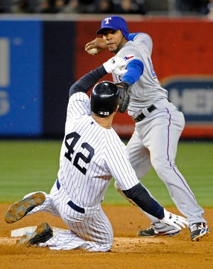 The New York Yankees' Nick Swisher (42) is out at second base as Texas shortstop Elvis Andrus relays the ball to first to complete a double play - one of six turned by the Rangers during their 5-3 win on Friday in New York.