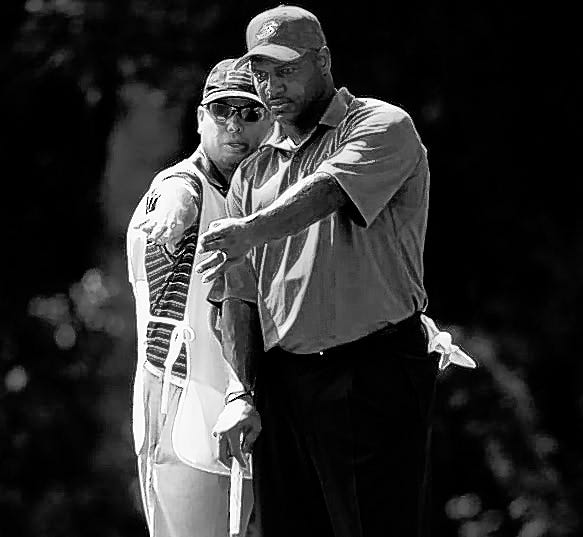 Derrick Brooks listens to his caddie before putting on the first hole 
during the opening round of the Champions Tour Outback Steakhouse Pro-Am 
golf tournament Friday in Lutz.ASSOCIATED PRESS / THE TAMPA TRIBUNE, SCOTT 
ISKOWITZ