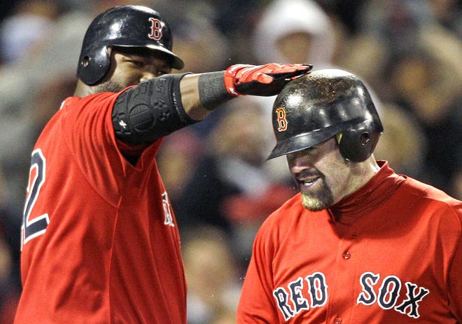 Boston's Kevin Youkilis, right, gets a tap on the helmet from teammate David Ortiz after hitting a two-run homer in the third inning.