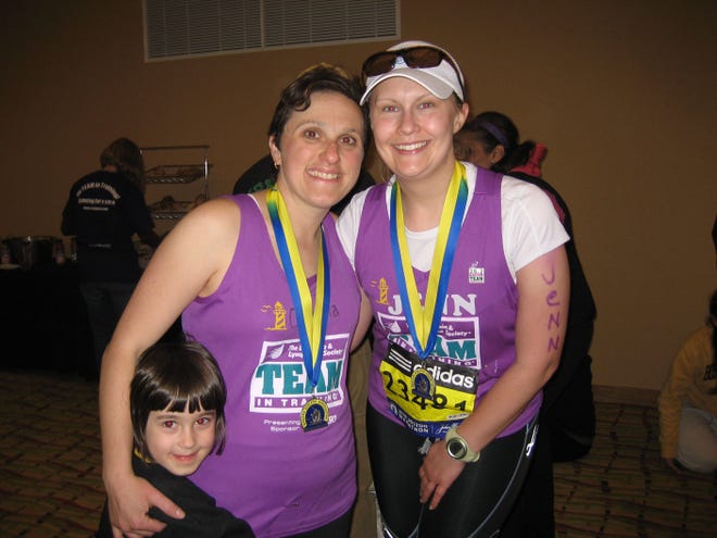 Jennifer Prohaska, right, of Natick, smiles with teammate Carmela Telese after the 2010 Boston Marathon.