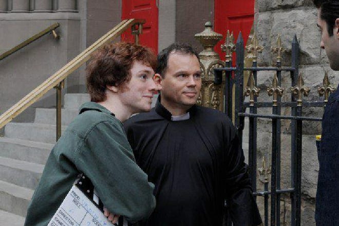 Brendan Steere, of Brodheadsville, left, director of ‘VelociPastor,’ consults with actors Tom Gilleece (Father Stewart) and Matt Ziegel (Father Jones, who finds his inner dinosaur) during filming in New York City.
