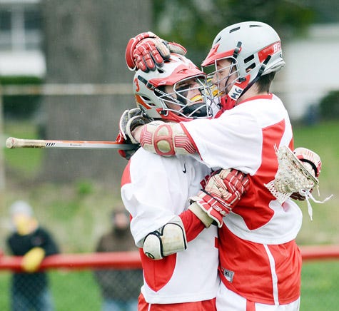 Canandaigua's Matt Scharr (left) and D.J. Goldstein celebrate after Goldstein scored in the second quarter for the Braves.