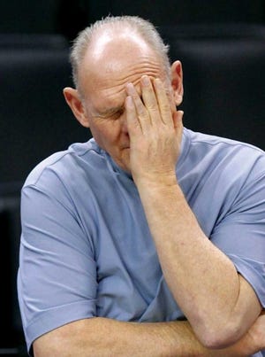 Denver Nuggets head coach George Karl wipes his eyes following a team practice in Oklahoma City Monday.
