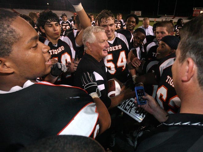 Waldon Tucker, pictured surrounded by players after his record setting Sept. 17, 2010 win over Haleyville, plans to retire after spending the last 27 seasons at Fayette County High School.