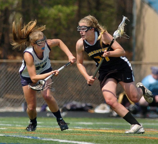 Stephanie Toy, right, of Moorestown High School heads downfield while defended by Kristin Kocher, left, of Shawnee High School during their game on Wednesday.  (BCT Staff Photograph/Dennis Mc Donald)