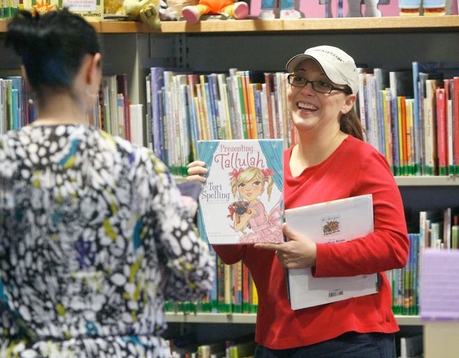 Lisa Snyder, left, and Heather Kreareas both of North Canton browse books for their children at the North Canton Library.
