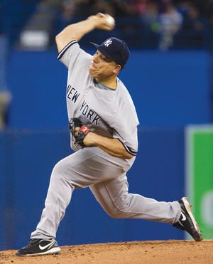 New York Yankees pitcher Bartolo Colon works against the Toronto Blue Jays during the fourth inning of a baseball game in Toronto on Wednesday, April 20, 2011. (AP Photo/The Canadian Press, Darren Calabrese)