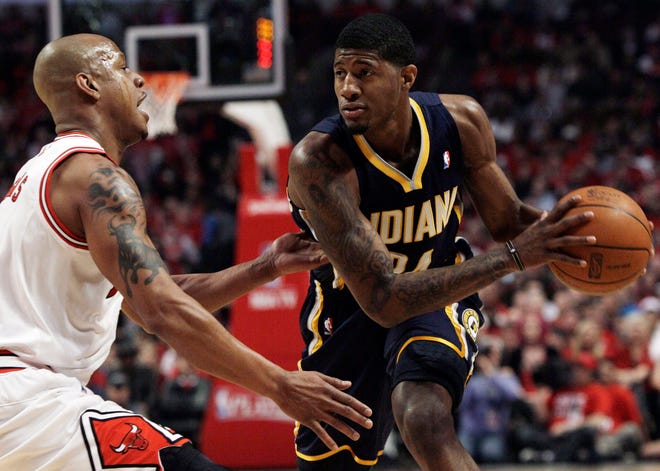 Indiana Pacers' Paul George, right, looks to a pass as Chicago Bulls' Keith Bogans defends during the first quarter in Game 2 of a first-round NBA playoff basketball series in Chicago, Monday, April 18, 2011.