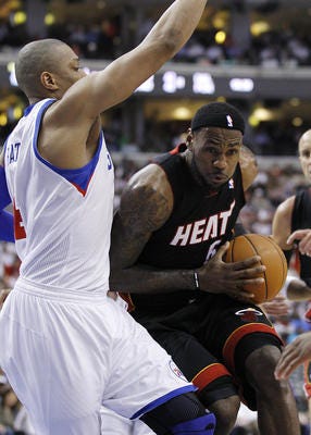 LeBron James (right) drives to the hoop against 76ers center Tony Battle during the first half of Game 3 on Thursday night.