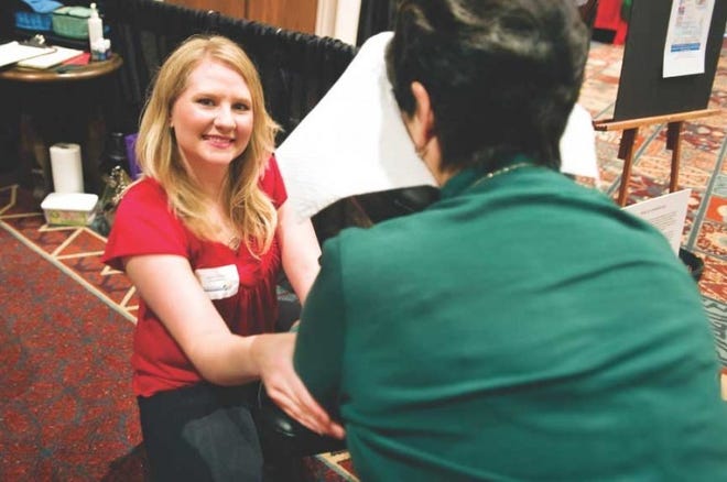 Stressbusters therapist Janetta Thomas (left) gives Liana Gutierrez a massage Thursday at The Pueblo Chieftain Business & Lifestyle Expo.