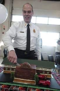 John Huff/Staff photographer 
Dover Fire Chief Perry Plummer cuts a replica cake of Liberty North End Fire Station at a retirement gathering in his honor Friday afternoon.