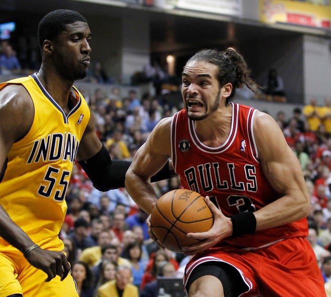Chicago Bulls' Joakim Noah, right, drives to the basket against Indiana Pacers' Roy Hibbert during the first half of Game 4 of a first-round NBA basketball series in Indianapolis, Saturday, April 23, 2011.