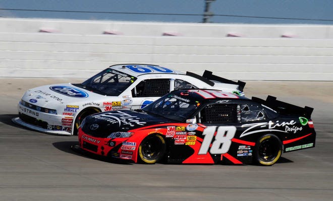 Kyle Busch (18) and Carl Edwards race down the backstretch at the Nashville Superspeedway during Saturday's NASCAR Nationwide Series Nashville 300. Edwards won the race.
