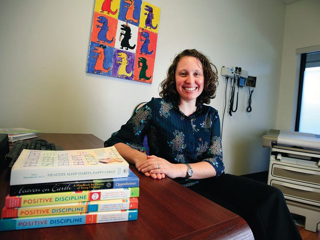 University of Florida Pediatrician Stephanie Ryan is shown with a selection of books she recommends.