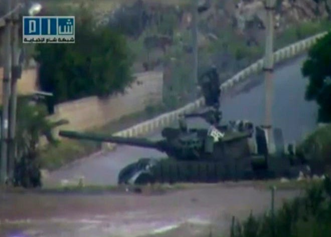 In an image taken from amateur video released by Sham News Network, a Syrian Freedom group, a tank is in Daraa, Syria yesterday.