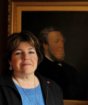 Genealogist Polly Kimmitt of Shrewsbury in her home with a portrait of her husband’s ancestor, William Henry Churton.