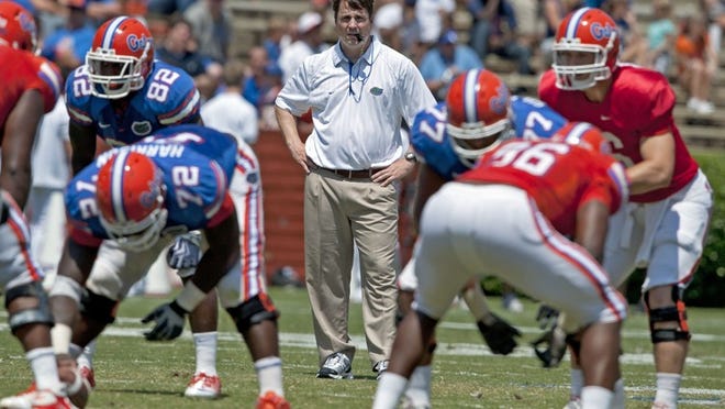Florida coach Wil Muschamp, center, watches his team during the Orange and Blue spring NCAA college football game in Gainesville, Fla., Saturday, April 9, 2011.