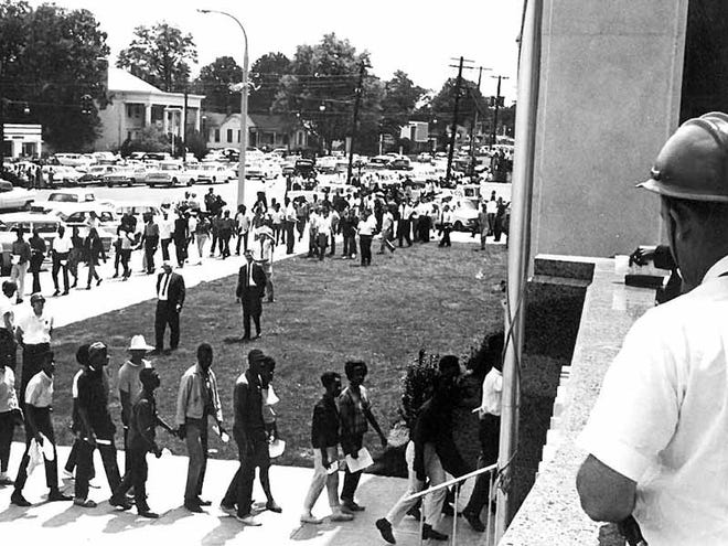 Civil rights activists march on the Tuscaloosa County Courthouse in this photo from the summer of 1964 recently found in old files at the Tuscaloosa County Sheriff's Office.
