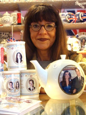 Jackie Gillam poses with some of the recent China of the royal couple that Fairchild’s received.