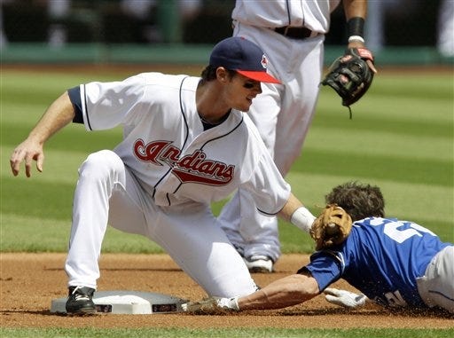 Cleveland Indians shortstop Jason Donald tags out Kansas City Royals' Scott Podsednik attempting to steal second base.