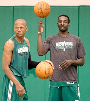 Boston Celtics' Jeff Green spins a ball on his fingure as teammate Ray Allen looks at teammates before practice in Waltham, Mass. Wednesday, April 27, 2011. (AP Photo/Winslow Townson)