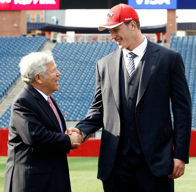 Patriots first-round draft choice Nate Solder (right) shakes hands with Patriots owner Robert Kraft in Foxboro yesterday.