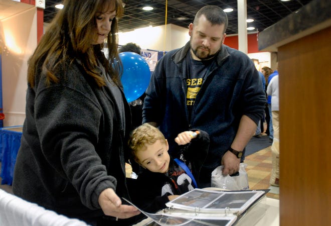 Anthony Tisi, 5, of Little Falls (center) spends some time with his grandparents, Chris (left) and Scott Ertley of Oriskany, who purchased a new house about a year ago, at the Home Expo 2011 in the old location of Circuit City at Sangertown Square in New Hartford on Saturday, April 30, 2011. The expo runs through Sunday, May 1st, until it closes its doors at 5pm.